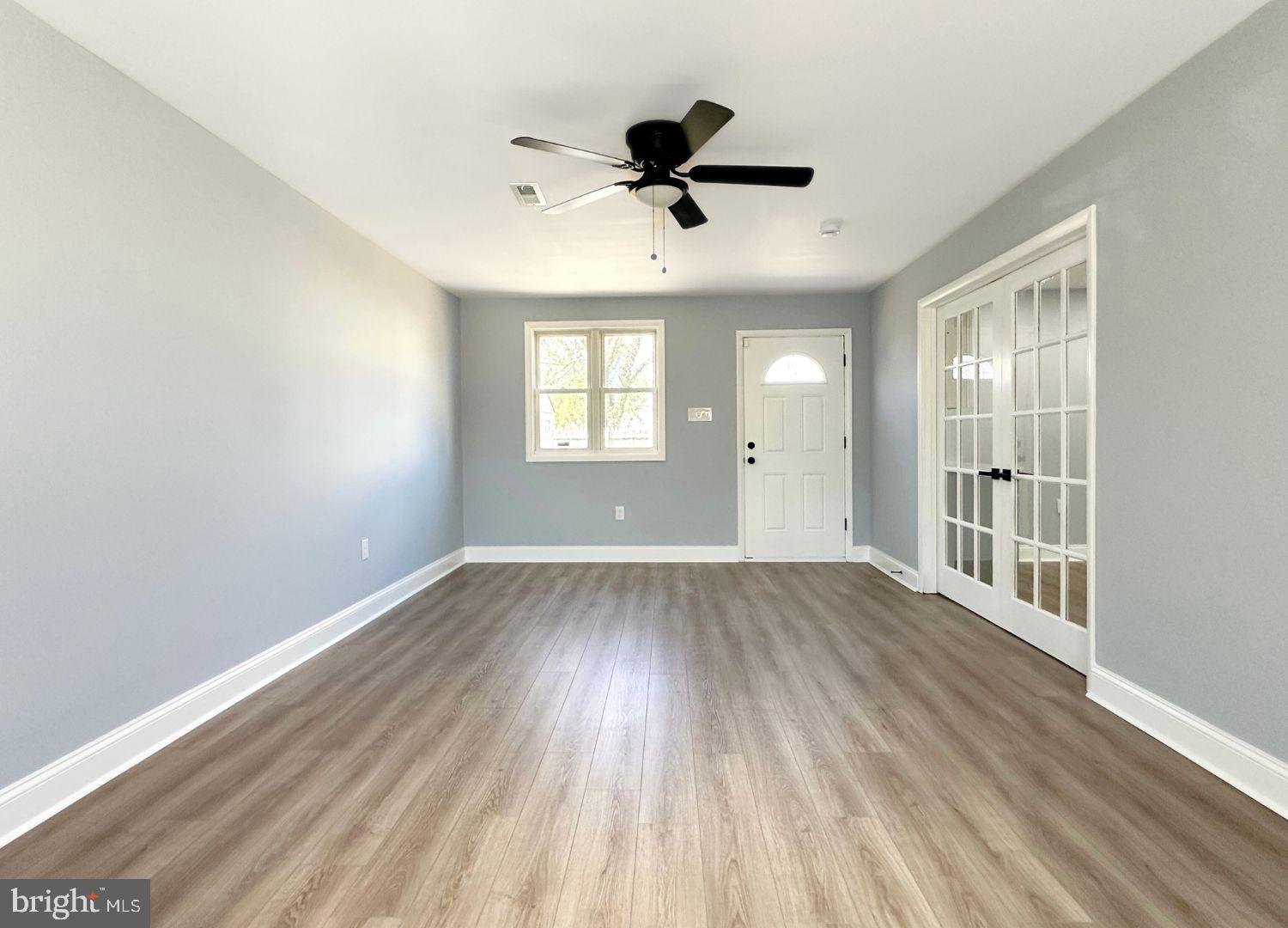 1855 Montreal Road Severn, MD 21144 - Photo 7 of 30 wooden floor in an empty room with a window