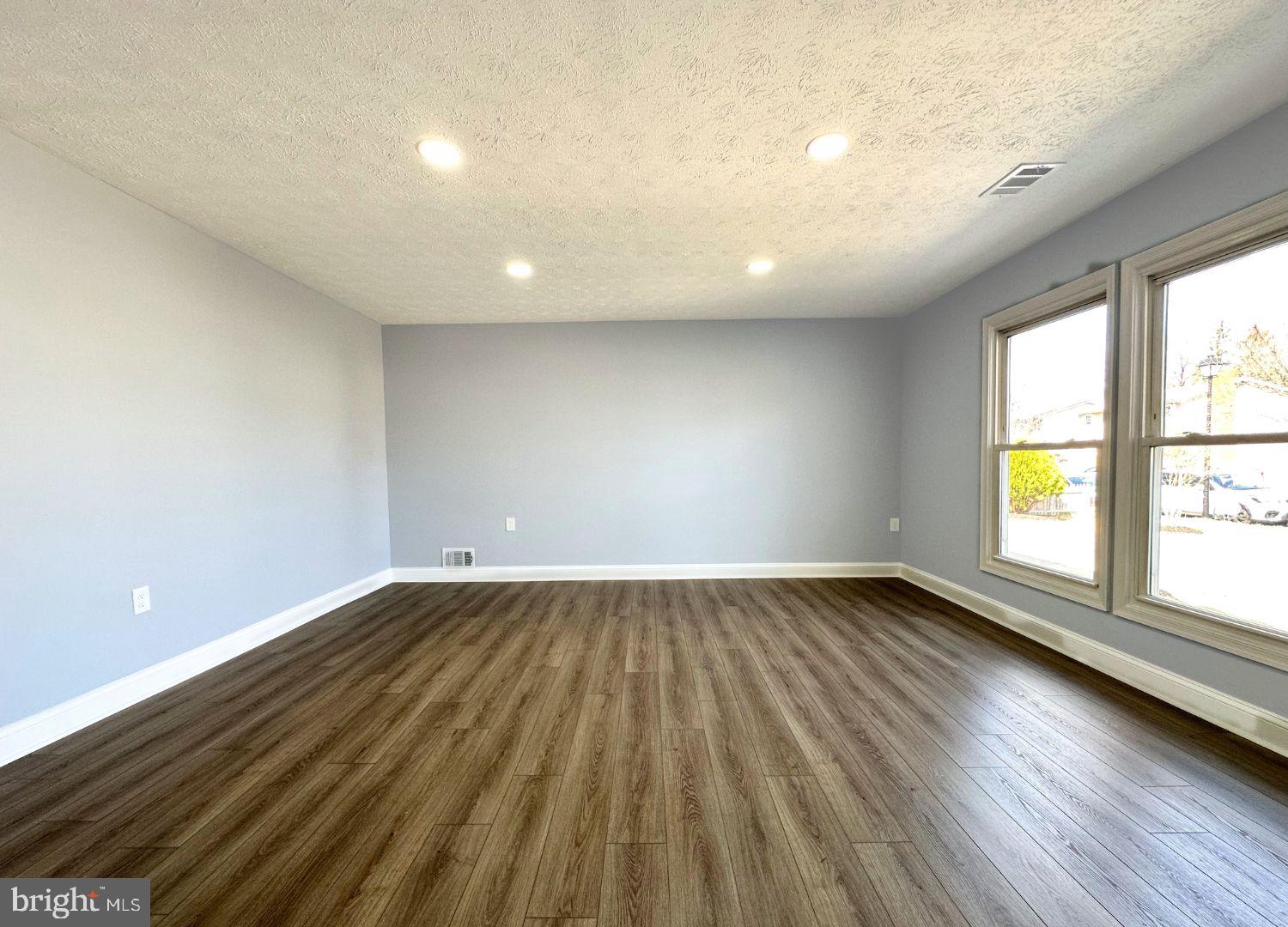 1855 Montreal Road Severn, MD 21144 - Photo 8 of 30 an empty room with wooden floor and windows