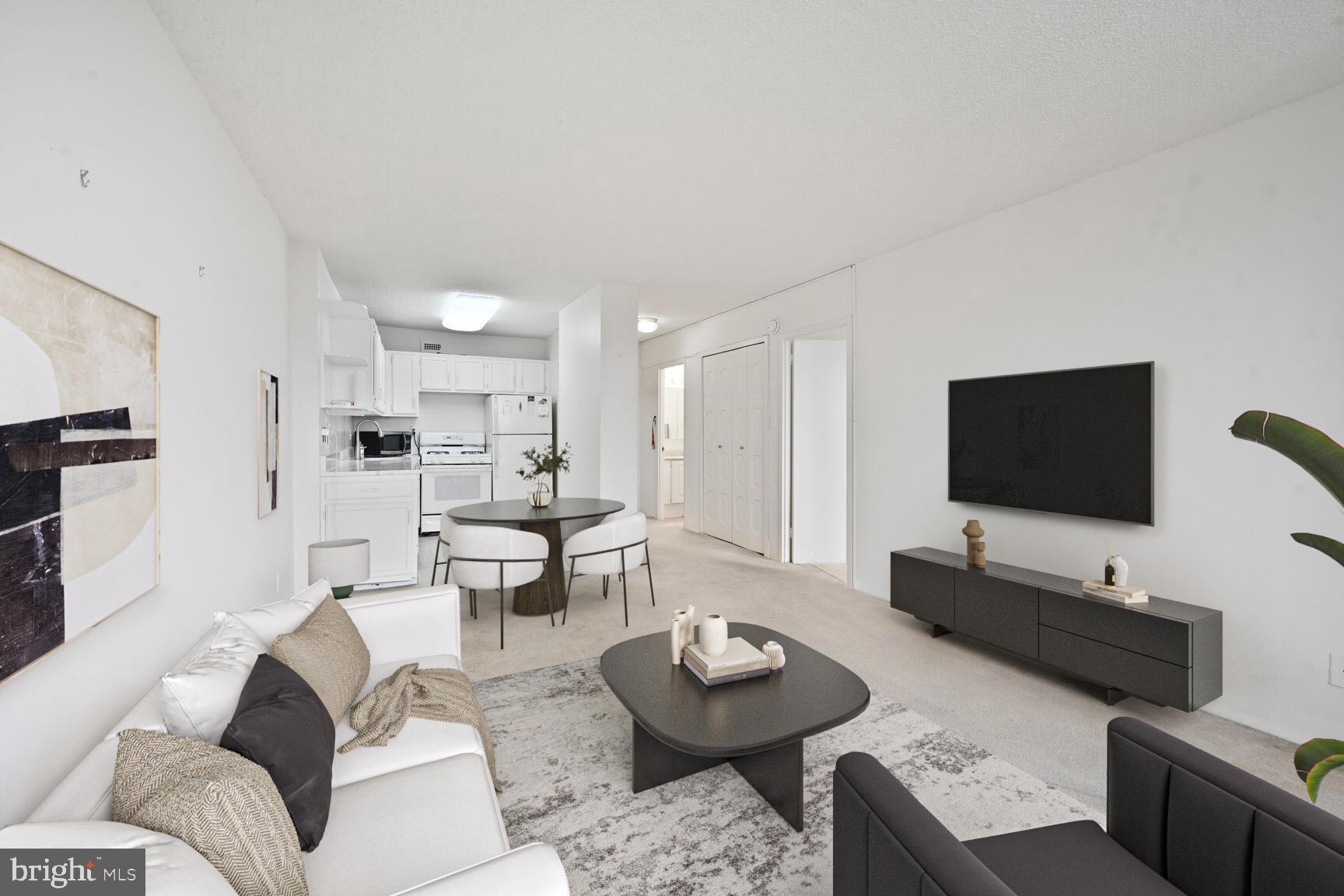 5225 Pooks Hill Road, Unit 1814N Bethesda, MD 20814 - Photo 3 of 31 a living room with furniture and a flat screen tv