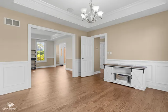 a view of an empty room and wooden floor