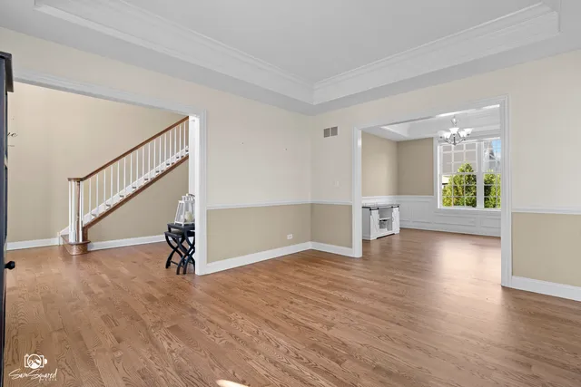 a view of empty room with wooden floor and window