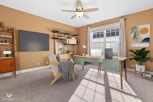 a work room with furniture and a flat screen tv