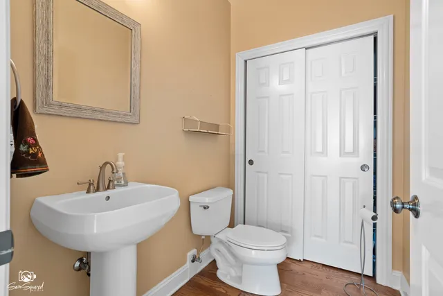 a bathroom with a toilet a sink and mirror