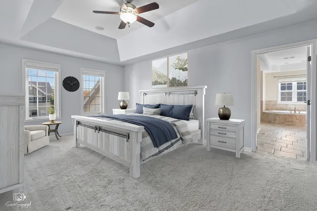 a bedroom with a large bed and a chandelier fan