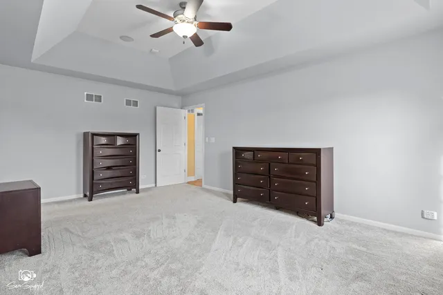 a room with furniture and a ceiling fan