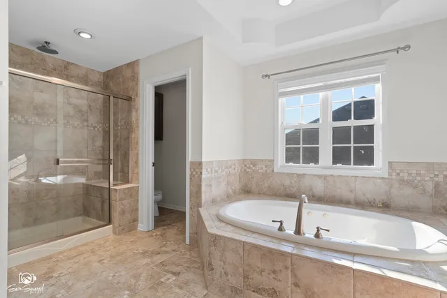 a bathroom with a bathtub and a shower