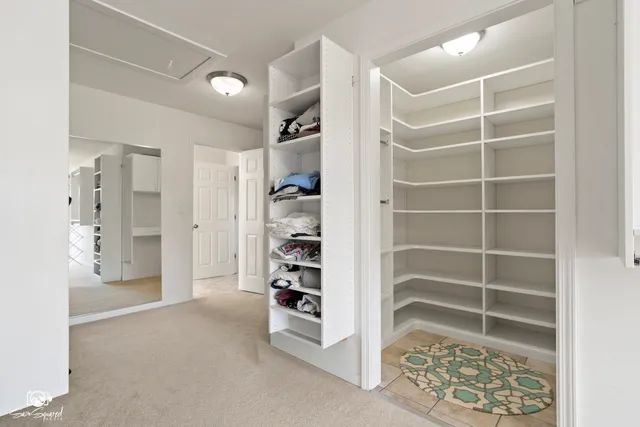 a view of walk in closet with empty racks