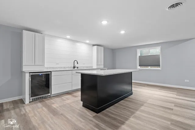 a kitchen with stainless steel appliances sink and cabinets