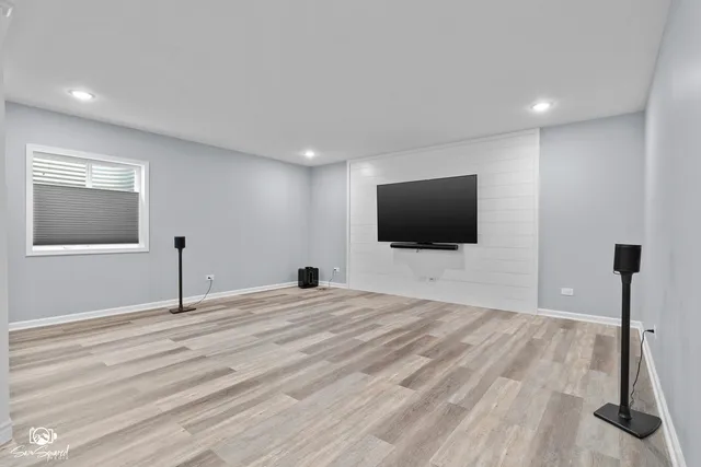 a view of a livingroom with wooden floor and flat screen tv