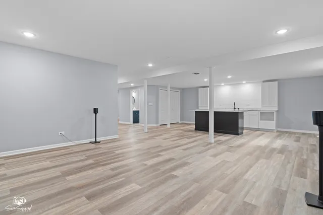 a view of an empty room with a kitchen