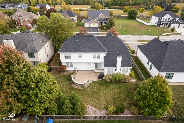 an aerial view of residential houses with outdoor space and swimming pool