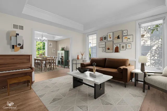 a living room with furniture a wooden floor and a large window