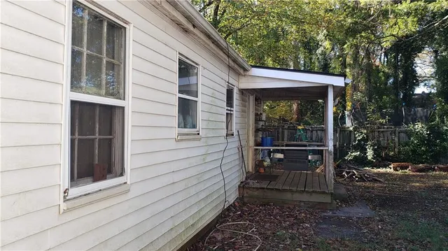 a view of a house with a yard and tree