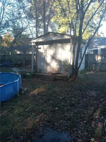 a view of a door of the house and tree