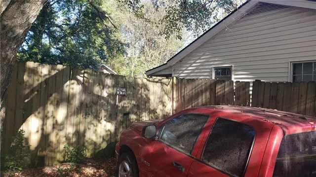 a view of backyard with deck and outdoor seating