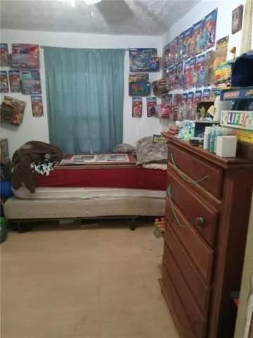 a bed sitting in a room next to a chair