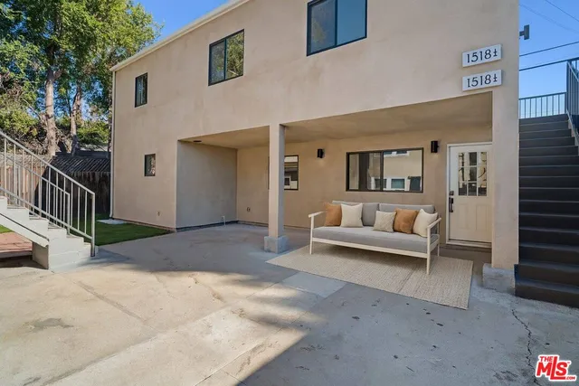 a view of a patio with couches and potted plants