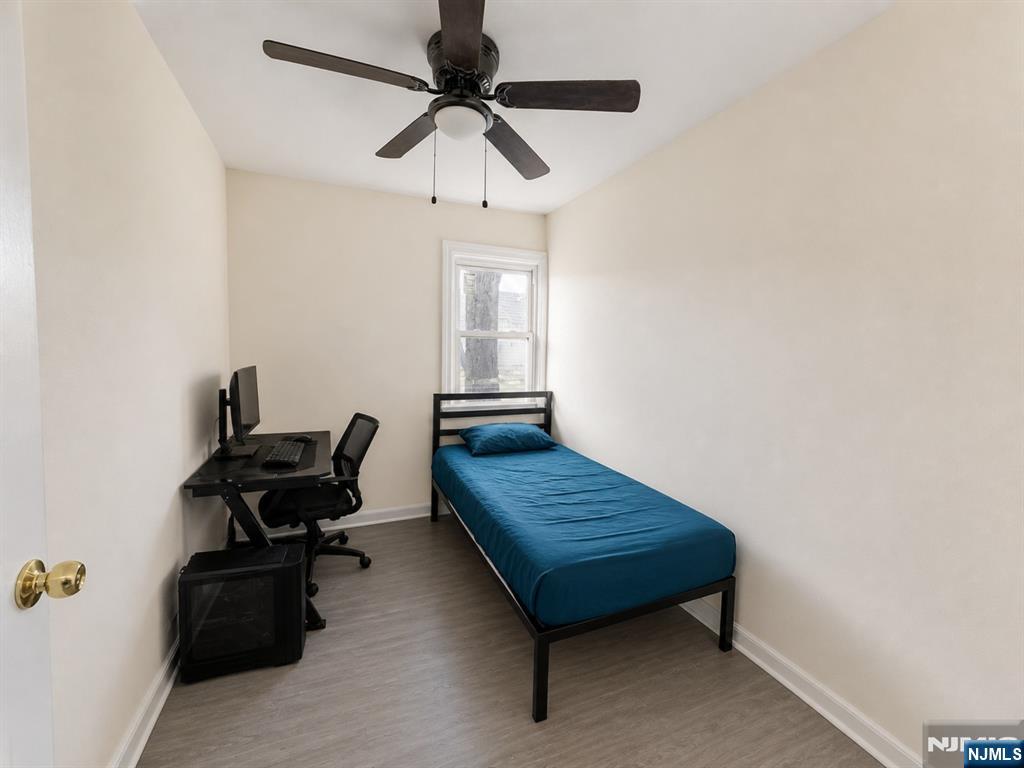270 Pacific Street, Unit 3 Paterson, NJ 07503 - Photo 5 of 11 a bedroom with a bed and a chandelier fan