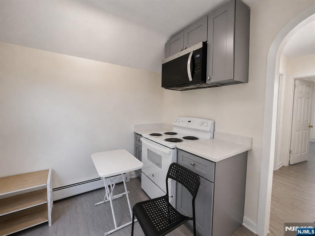 270 Pacific Street, Unit 3 Paterson, NJ 07503 - Photo 9 of 11 a kitchen with a stove and a microwave