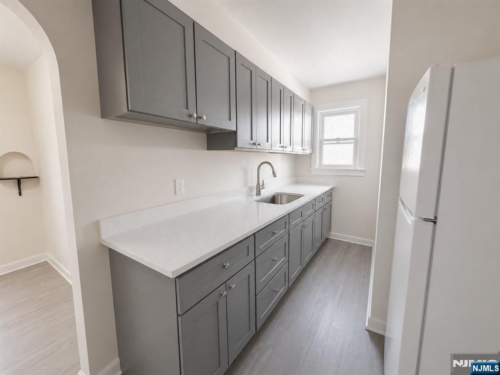 270 Pacific Street, Unit 3 Paterson, NJ 07503 - Photo 10 of 11 a kitchen with a sink a refrigerator and cabinets