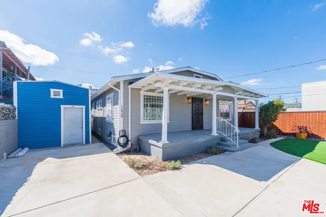 a front view of a house with a yard and seating space