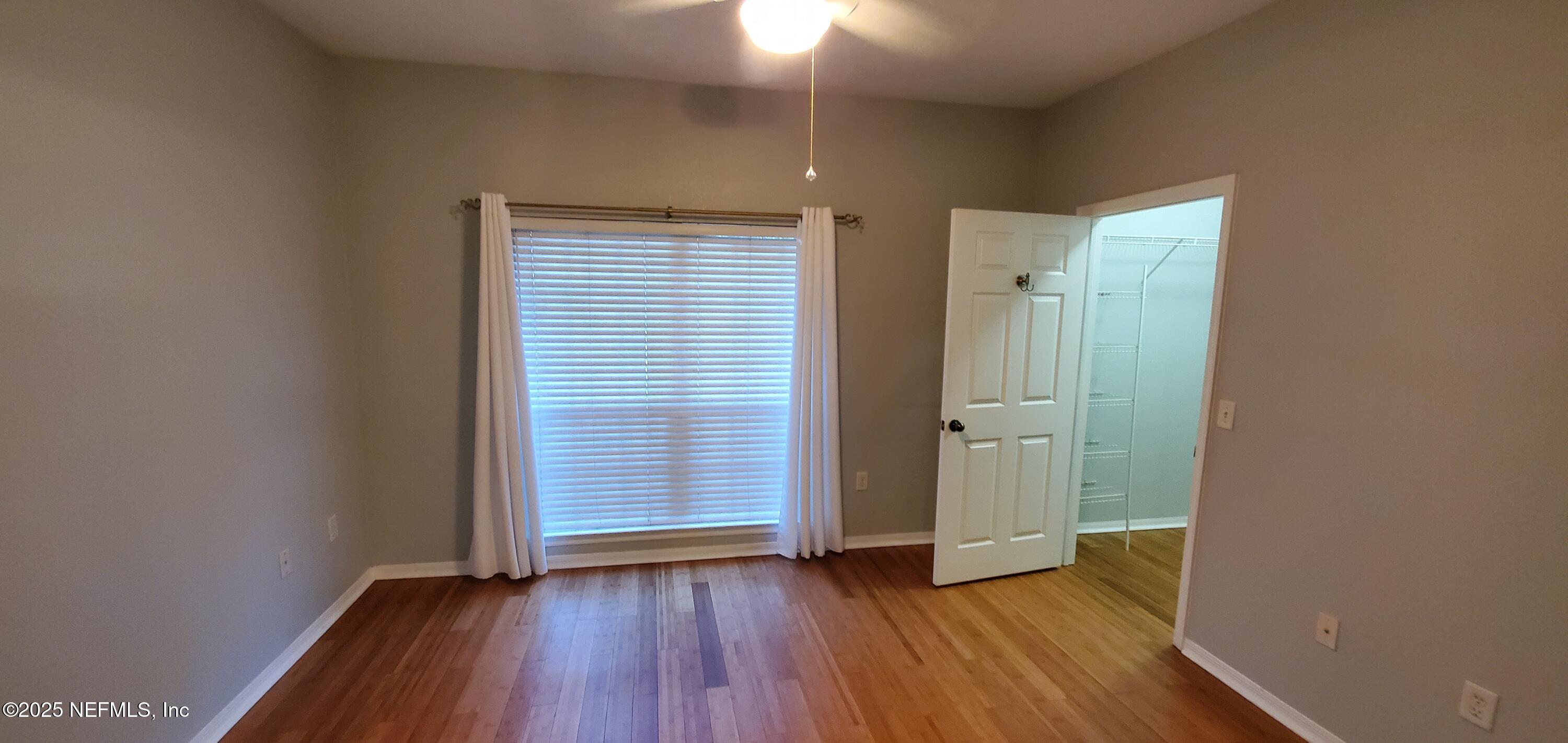 7800 Point Meadows Drive, Unit 1012 Jacksonville, FL 32256 - Photo 12 of 38 an empty room with closet and wooden floor