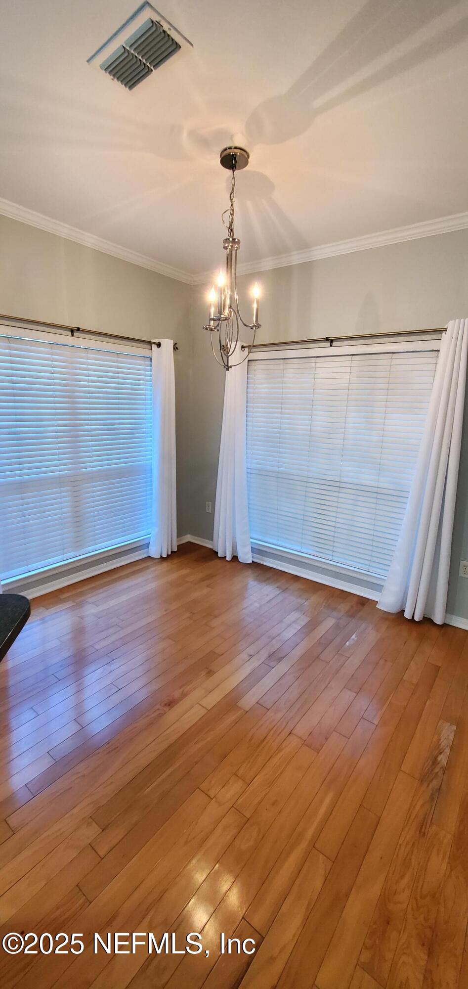 7800 Point Meadows Drive, Unit 1012 Jacksonville, FL 32256 - Photo 16 of 38 wooden floor in an empty room with a window