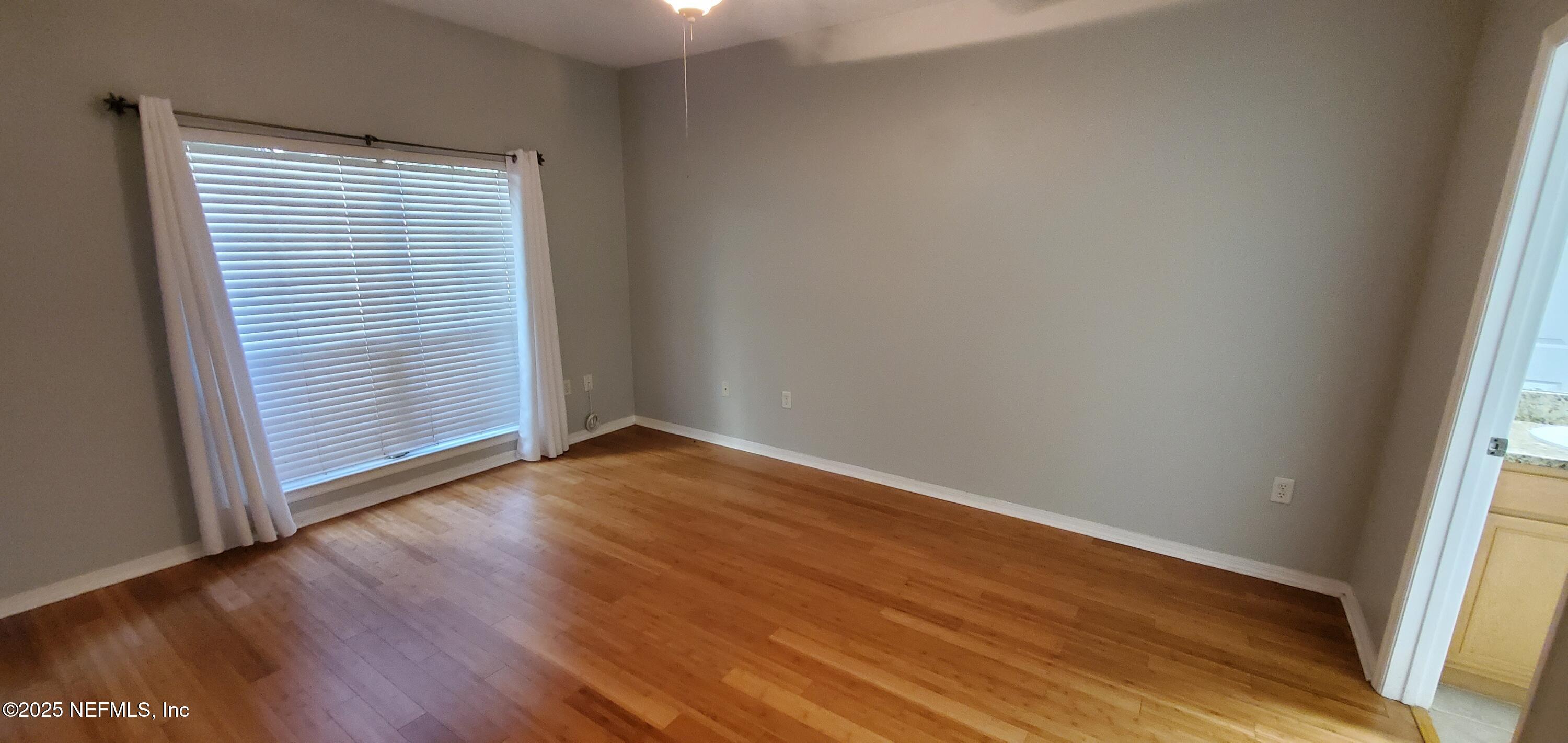 7800 Point Meadows Drive, Unit 1012 Jacksonville, FL 32256 - Photo 24 of 38 an empty room with wooden floor and windows