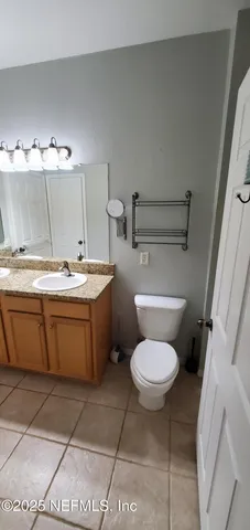 a bathroom with a sink a toilet and a mirror