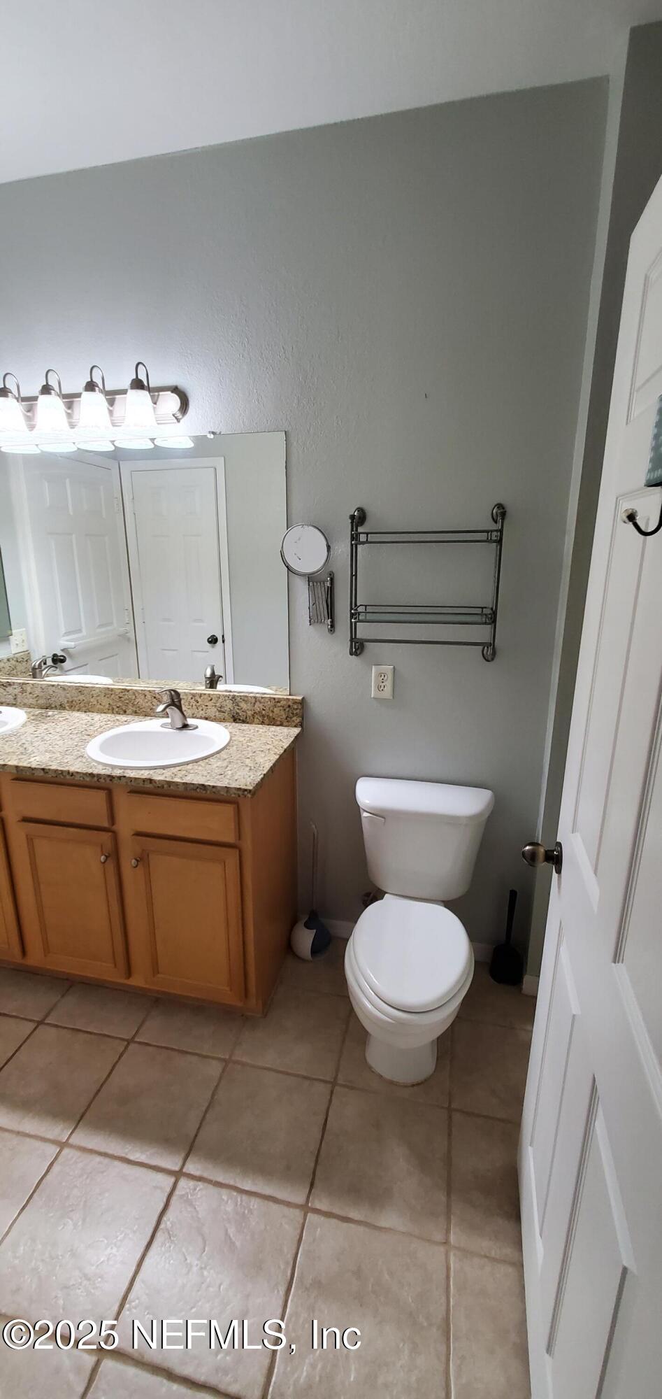 7800 Point Meadows Drive, Unit 1012 Jacksonville, FL 32256 - Photo 31 of 38 a bathroom with a sink a toilet and a mirror