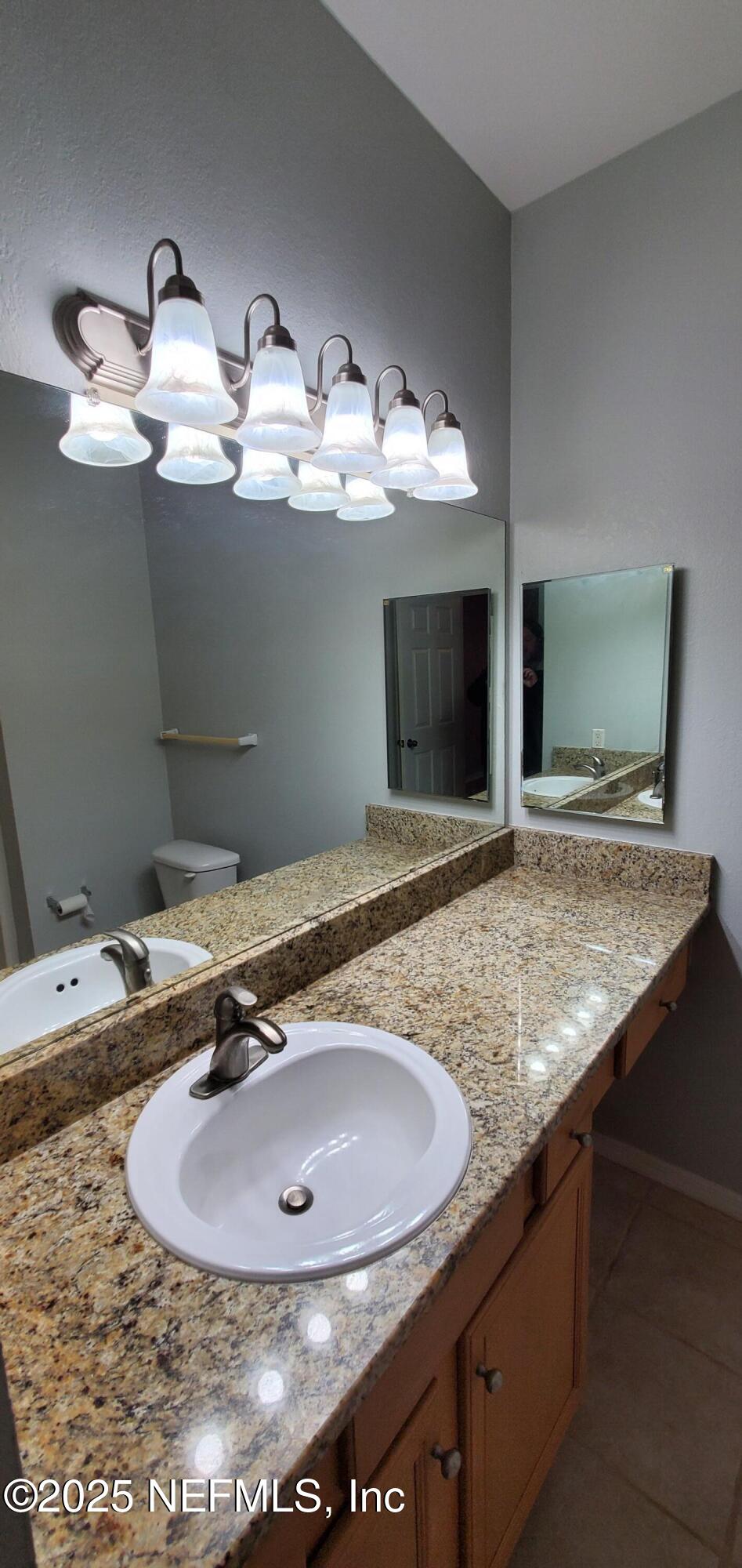 7800 Point Meadows Drive, Unit 1012 Jacksonville, FL 32256 - Photo 9 of 38 a bathroom with a sink and a mirror