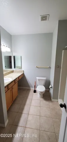 a bathroom with a sink a toilet and mirror
