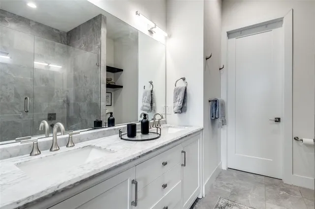 a bathroom with double vanity sinks and a mirror