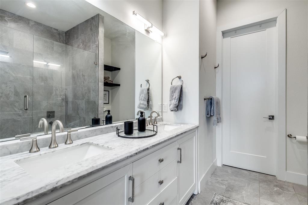 4640 Munger Avenue, Unit 104 Dallas, TX 75204 - Photo 22 of 26 a bathroom with double vanity sinks and a mirror