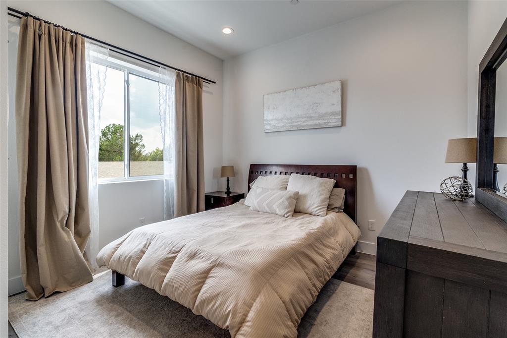 4640 Munger Avenue, Unit 104 Dallas, TX 75204 - Photo 24 of 26 a bedroom with a bed and a desk