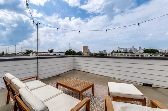 a terrace with outdoor seating and city view