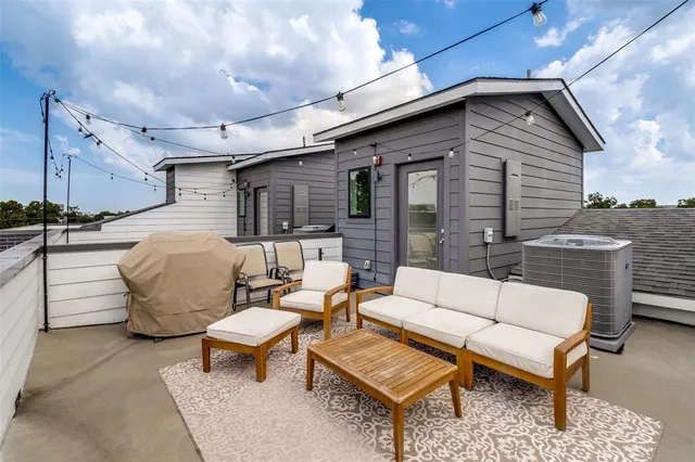 a balcony with furniture and a potted plant