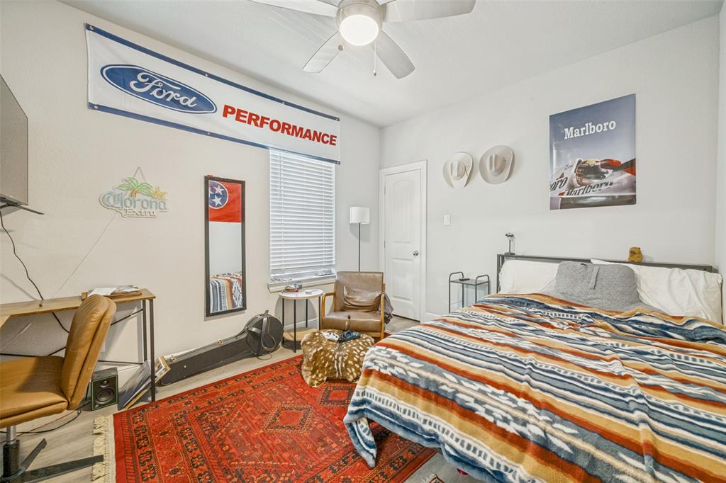3545 Rashti Court Fort Worth, TX 76109 - Photo 18 of 36 a bedroom with a bed and wooden floor