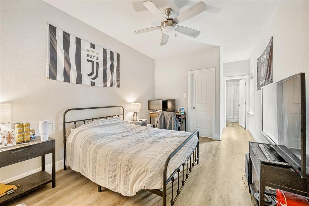 3545 Rashti Court Fort Worth, TX 76109 - Photo 23 of 36 a bedroom with a bed a flat screen tv and dresser
