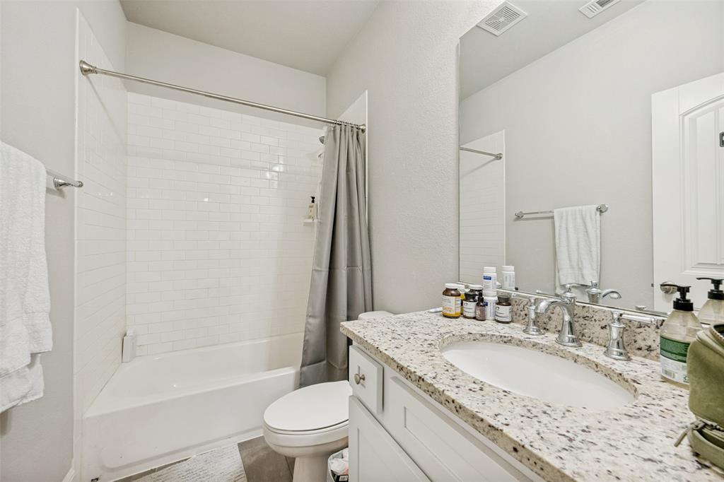 3545 Rashti Court Fort Worth, TX 76109 - Photo 26 of 36 a bathroom with a granite countertop sink toilet and shower