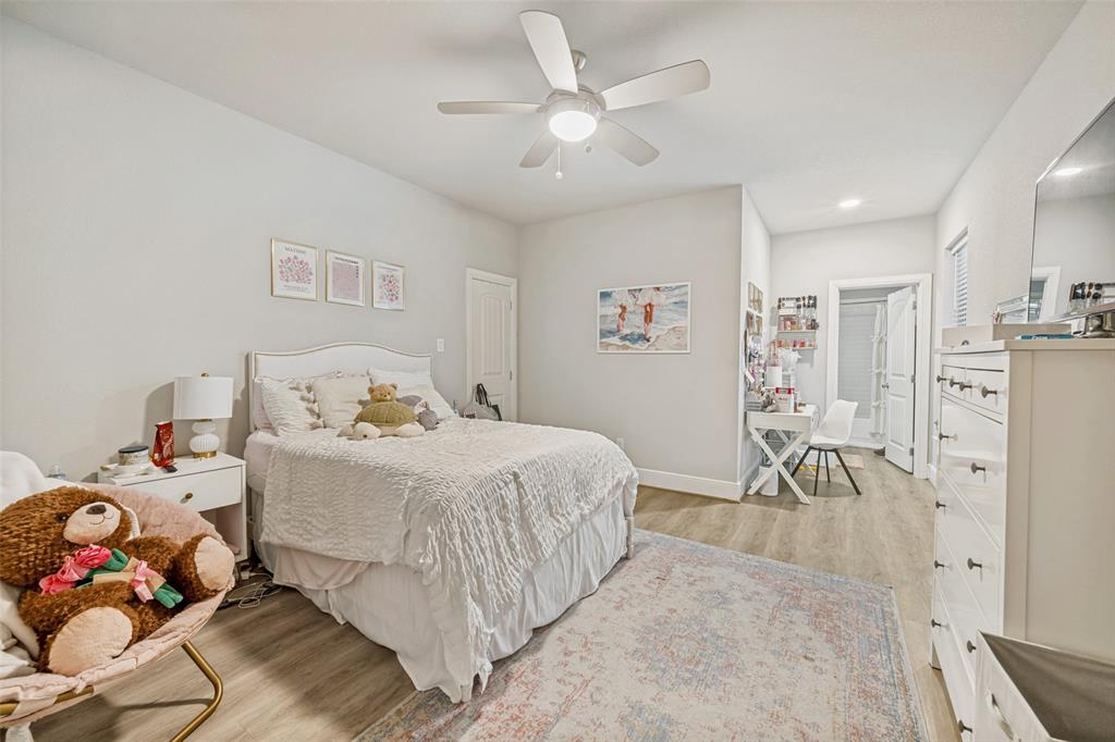 3545 Rashti Court Fort Worth, TX 76109 - Photo 27 of 36 a bedroom with a bed and a chandelier