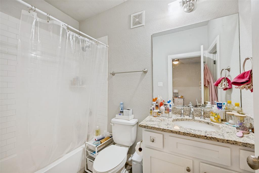 3545 Rashti Court Fort Worth, TX 76109 - Photo 29 of 36 a bathroom with a granite countertop sink mirror vanity and toilet
