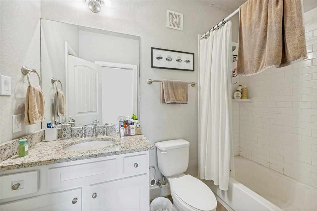 3545 Rashti Court Fort Worth, TX 76109 - Photo 31 of 36 a bathroom with a granite countertop toilet sink and shower