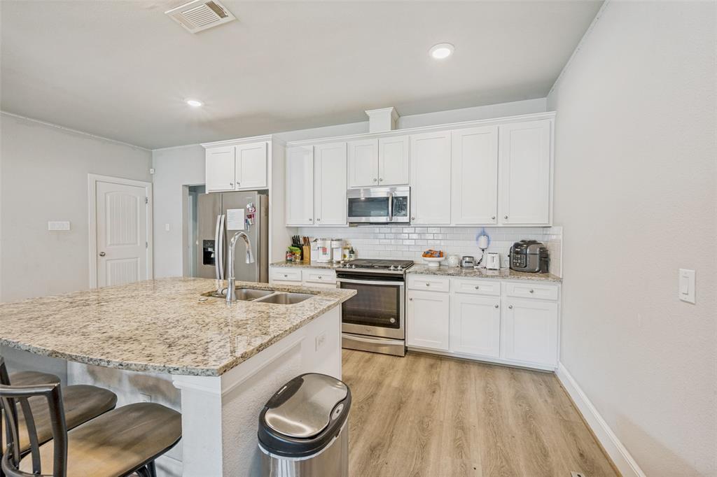 3545 Rashti Court Fort Worth, TX 76109 - Photo 9 of 36 a kitchen with a stove a sink and a refrigerator