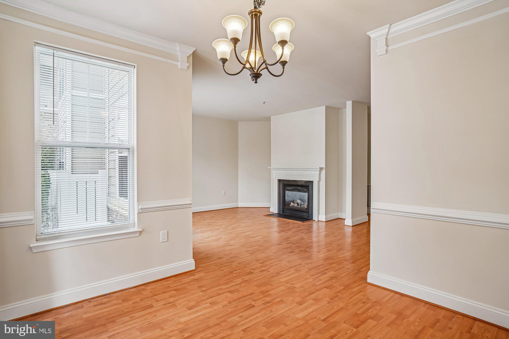 12824 Clarksburg Square Road, Unit 102 Clarksburg, MD 20871 - Photo 11 of 75 a view of an empty room with wooden floor and a window
