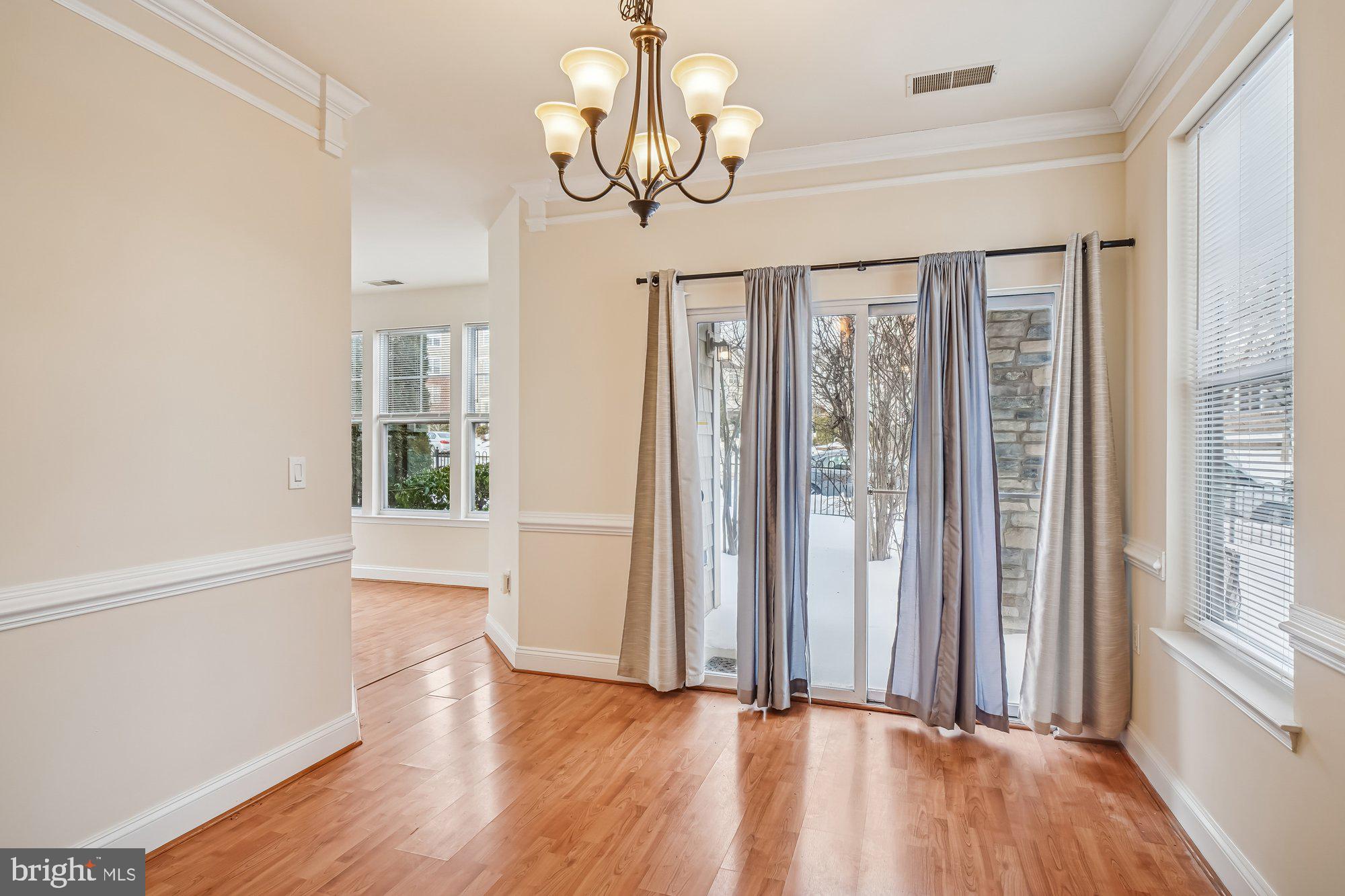 12824 Clarksburg Square Road, Unit 102 Clarksburg, MD 20871 - Photo 12 of 75 a view of a room with wooden floor and windows