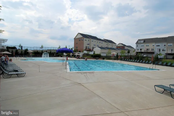 a view of swimming pool and outdoor seating
