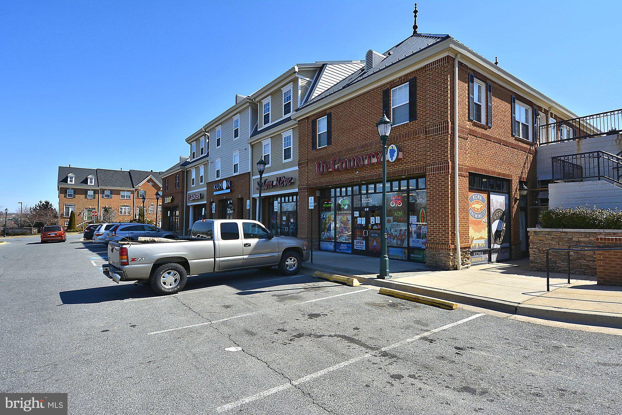 12824 Clarksburg Square Road, Unit 102 Clarksburg, MD 20871 - Photo 39 of 75 a car parked in front of a white building