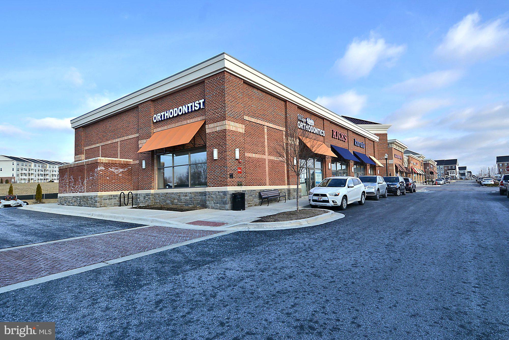 12824 Clarksburg Square Road, Unit 102 Clarksburg, MD 20871 - Photo 40 of 75 a front view of a house with a yard and garage