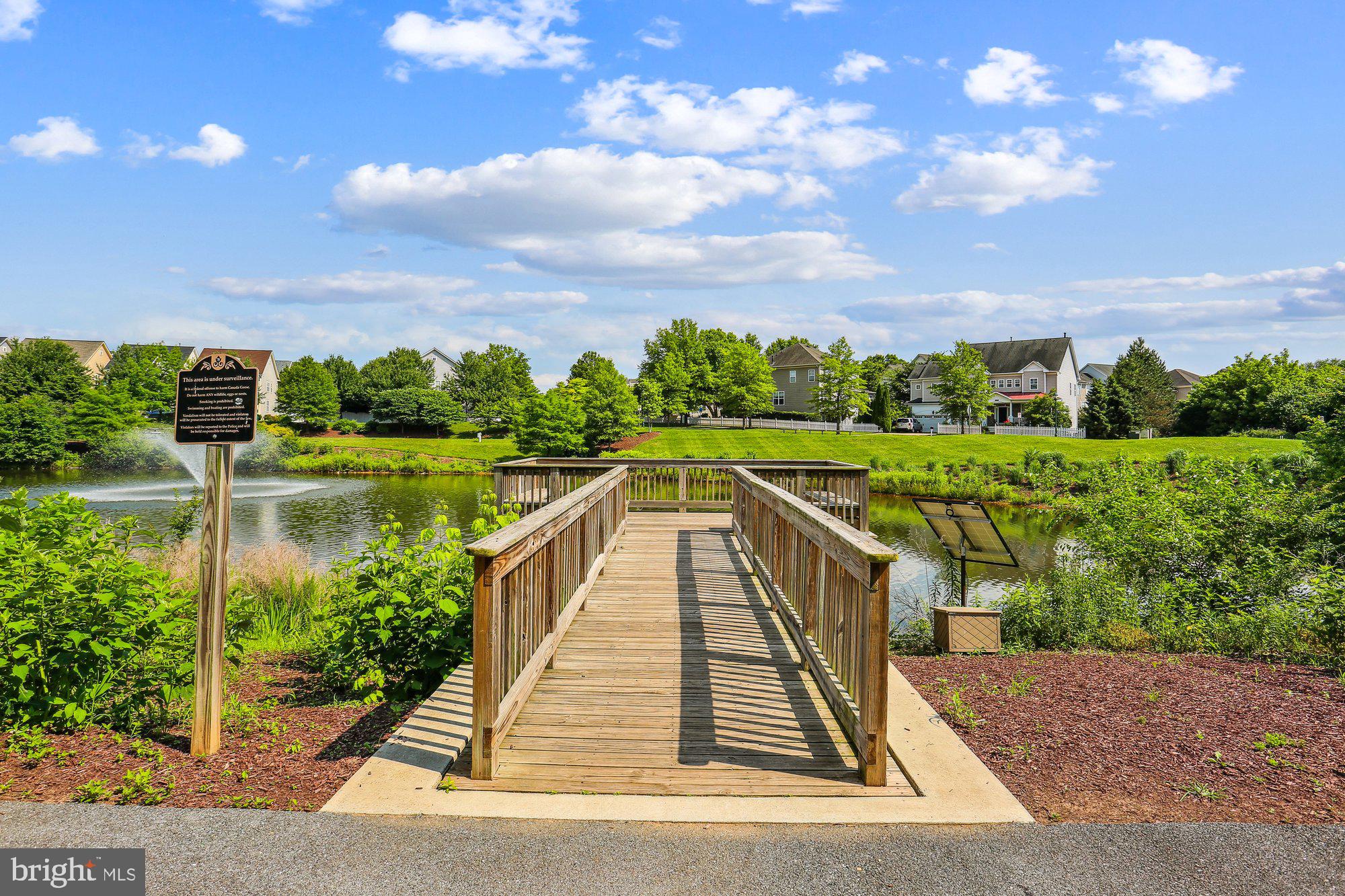 12824 Clarksburg Square Road, Unit 102 Clarksburg, MD 20871 - Photo 65 of 75 a view of a lake with a house in the background